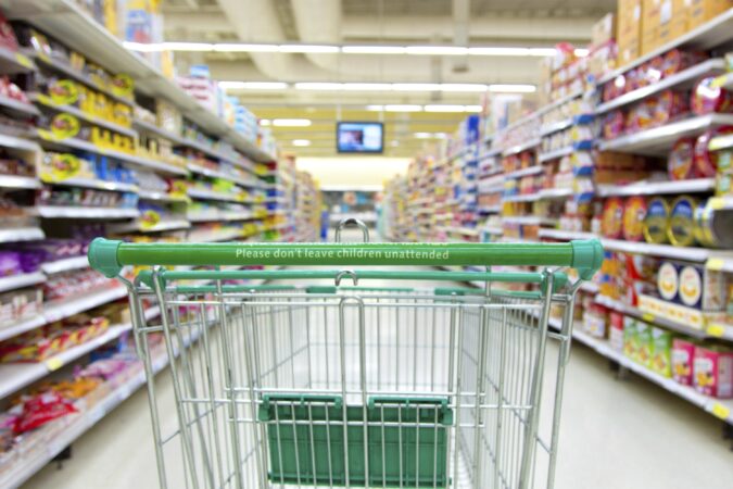 shopping trolley in supermarket aisle